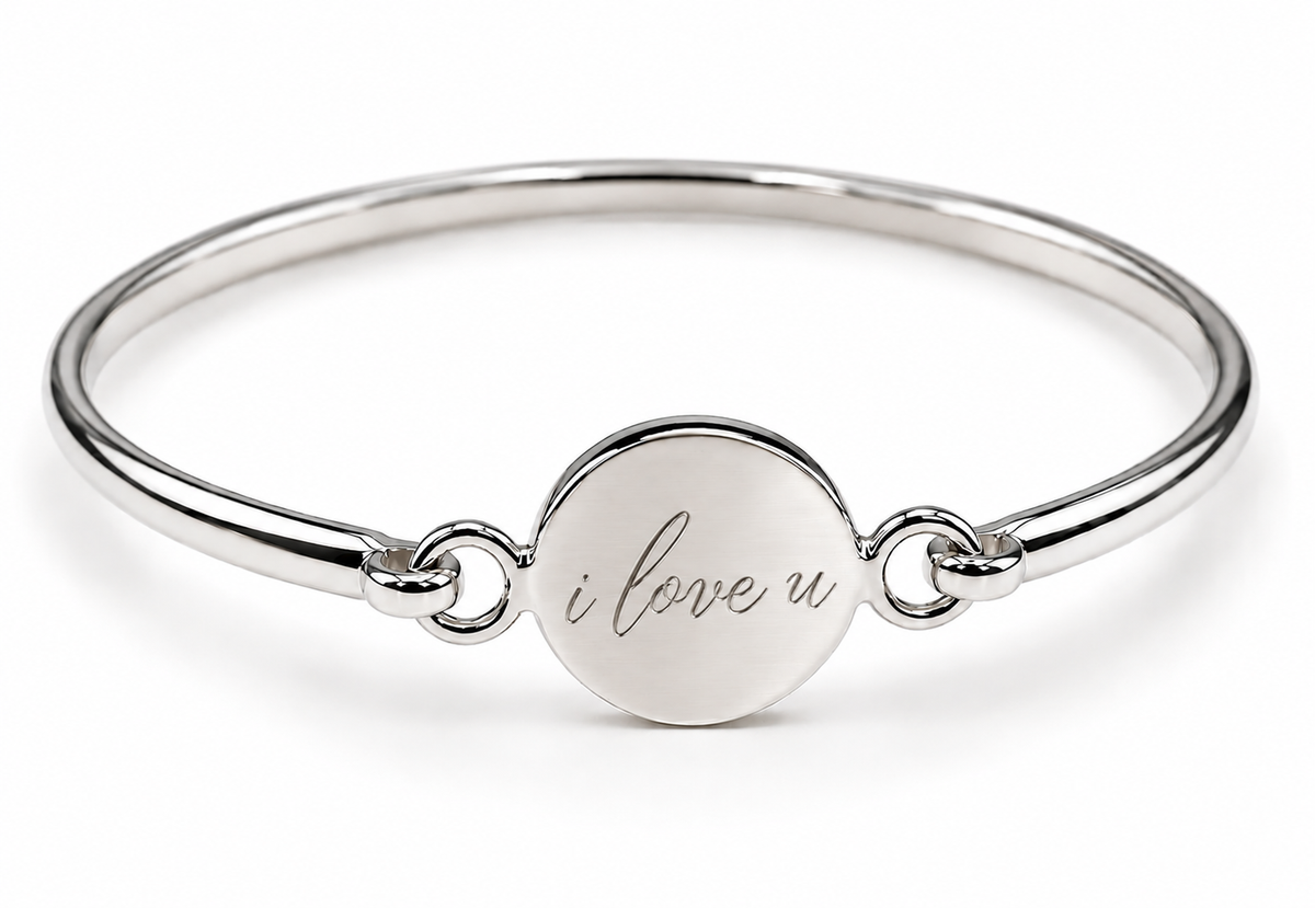 Polished sterling silver round disc bangle showing an 'i love u' engraving example.