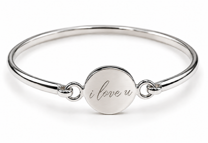Polished sterling silver round disc bangle showing an 'i love u' engraving example.