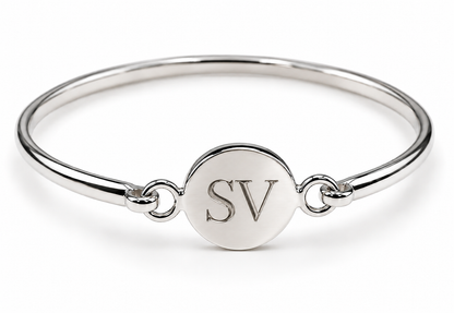Sterling silver round disc bangle showing an SV initials engraving example.