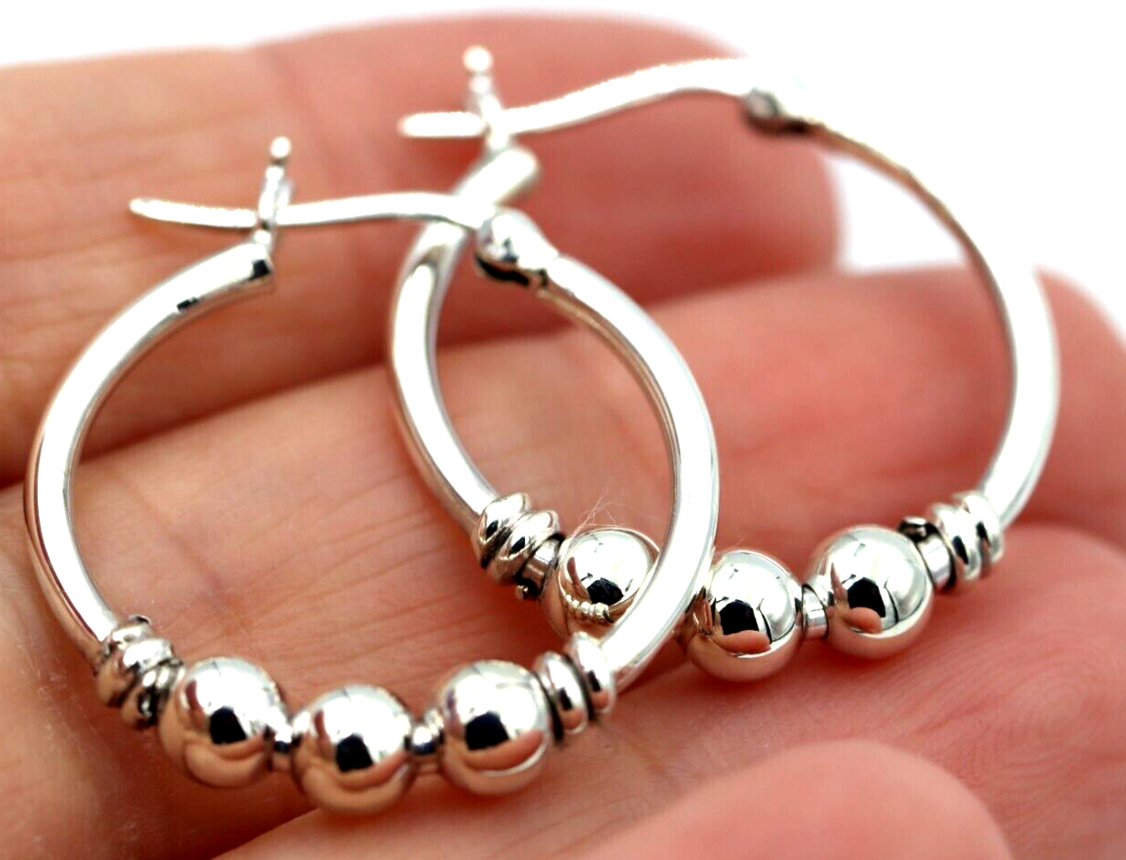 Hoop earrings with balls 2025 on them